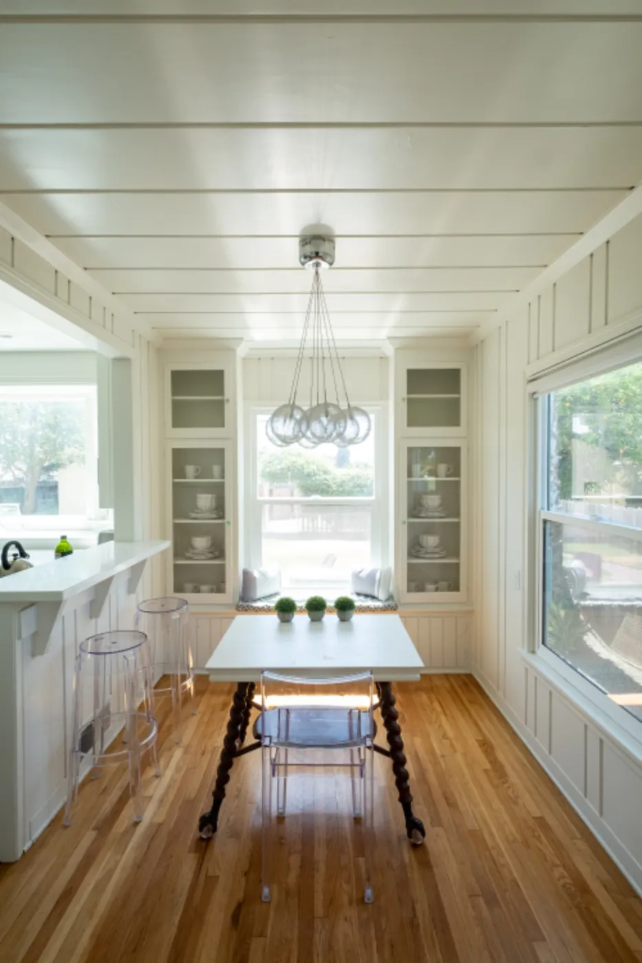 Bright dining room with a hardwood floor and built-in cabinets