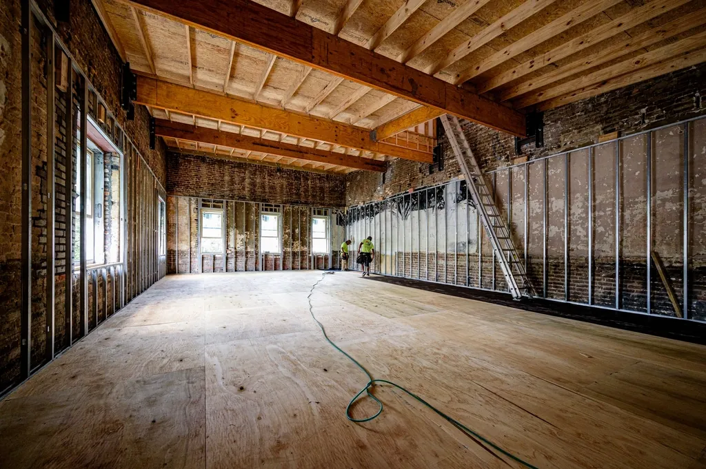 Open room framed and stripped to the subfloor during a renovation
